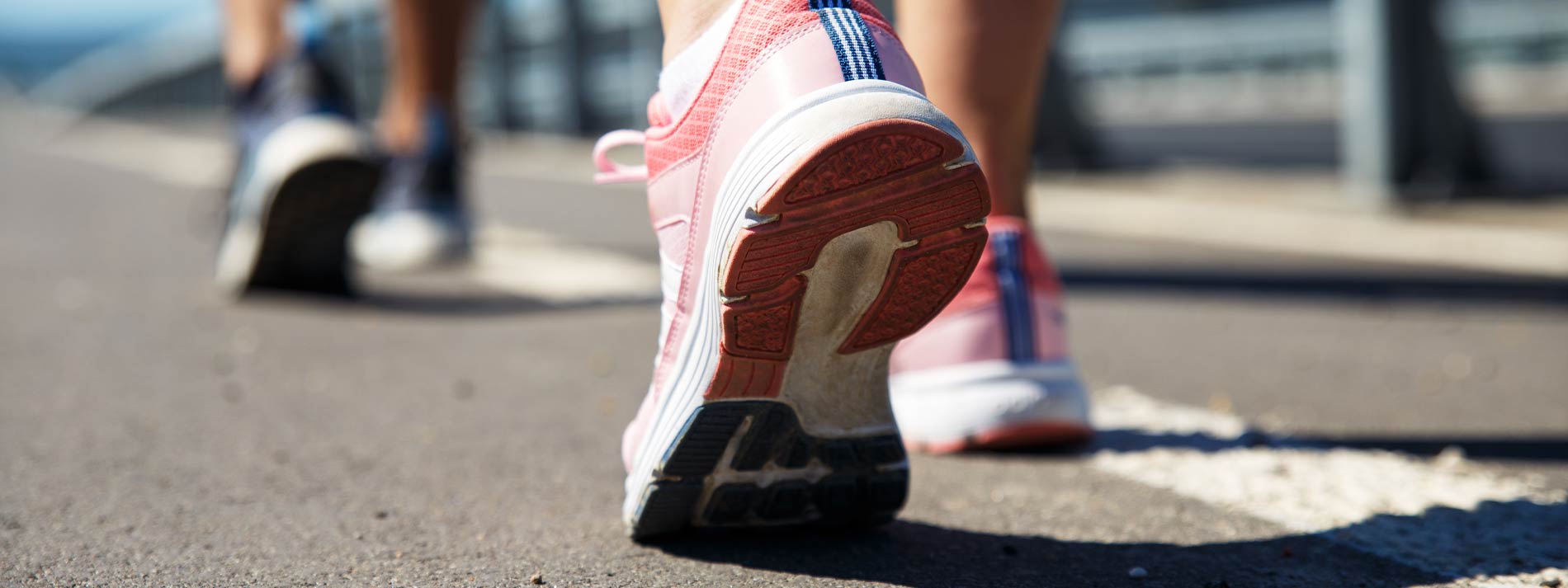 Running shoe against dirt trail